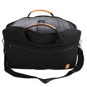 Black canvas laptop bag with front zipper, shoulder strap, and tan-trim handle