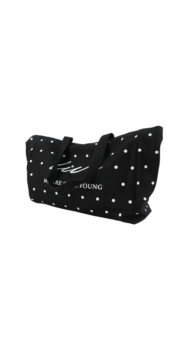 Black dot tote bag with two handles and white star-like dots, front slogan print