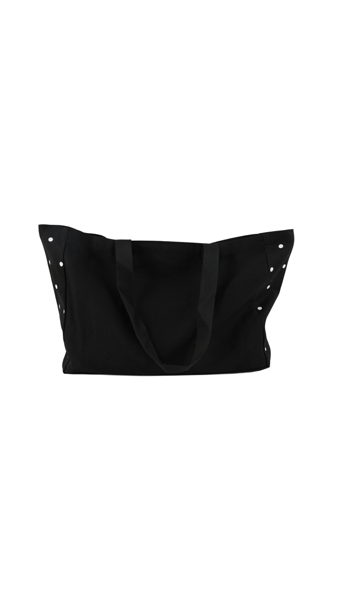 Black dot tote bag with open top and draped front, white dot accents