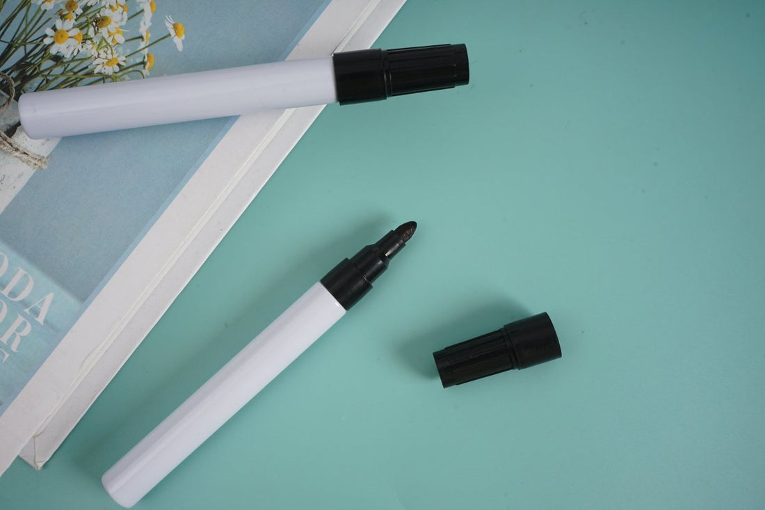Black marker pens, white barrel with black cap