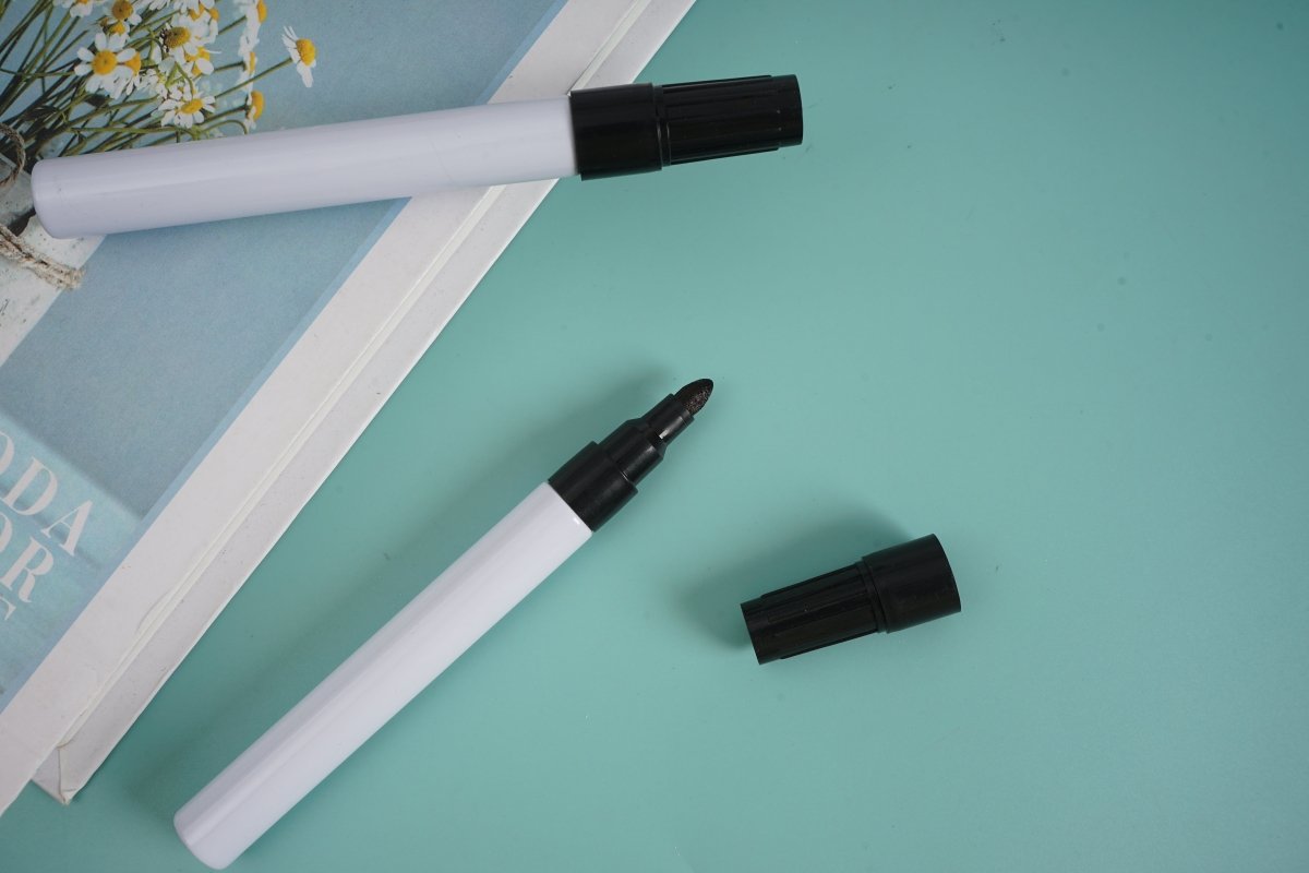 Black marker pens, white barrel with black cap