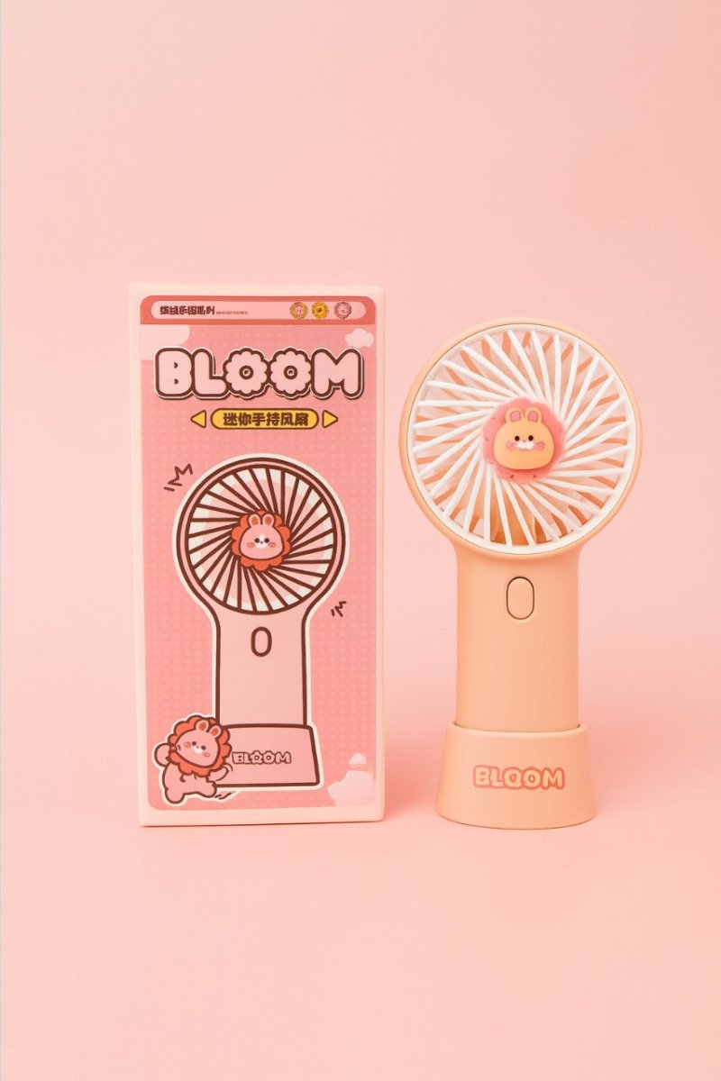 Pink mini fan with bear face grille and oval button, shown with retail box