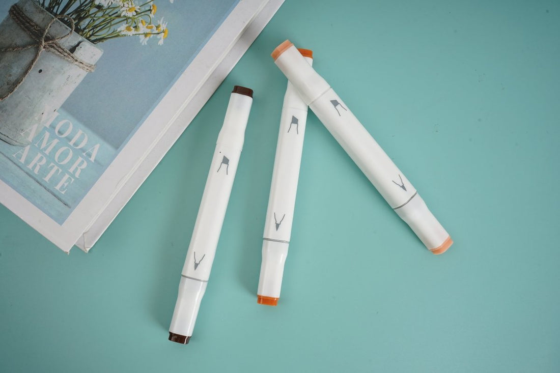 Three brown highlighter pens with orange caps and tips, white barrels