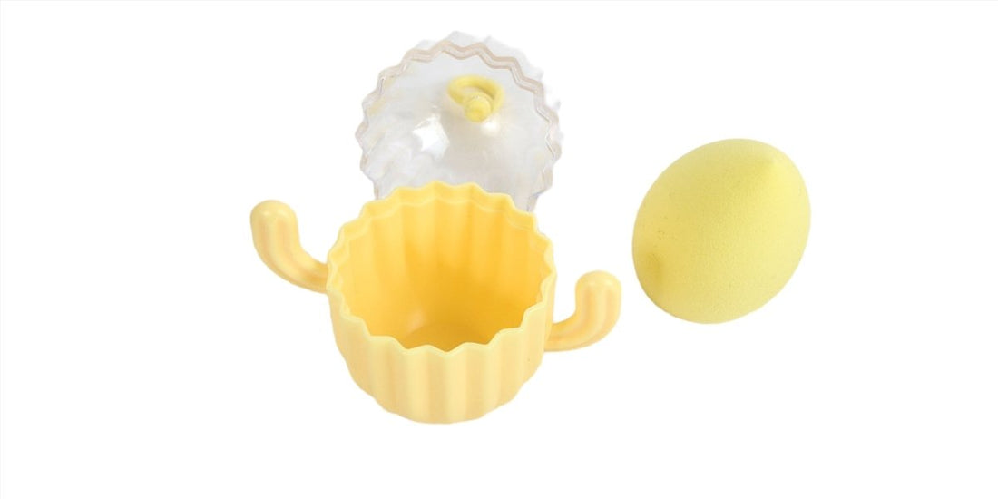 Cactus makeup sponge holder with yellow base, clear top, and round yellow sponge