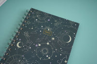 Celestial notebook cover close-up with moons, stars, and a small CRAFT label.