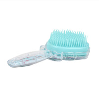 Plastic hair brush with shell-shaped bristles, teal head and clear handle detail.