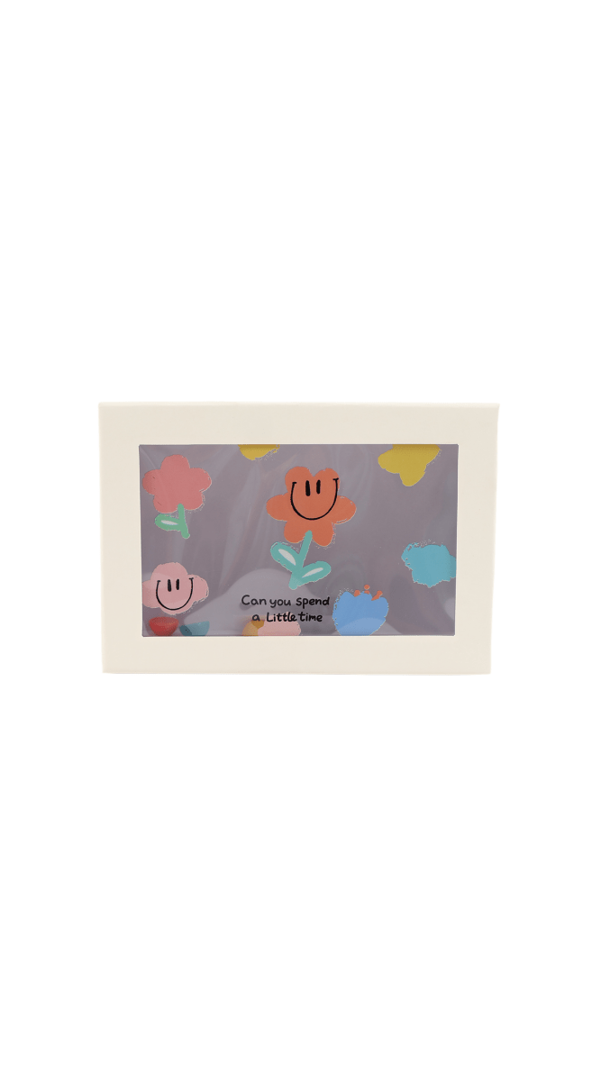 Decorated gift box with cartoon faces and pastel shapes on the front