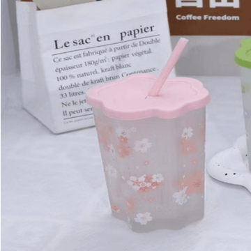Pink plastic tumbler with cherry blossom pattern, pink lid and straw