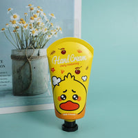 Yellow hand cream tube with flip-top cap and character face label