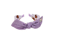 Violet fabric headband with soft knotted bow and animal-print accents at the ends