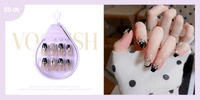 False nail pouch with black-and-white designs; nails shown on fingers