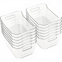 Stack of clear plastic storage bins with vented side handles and open tops