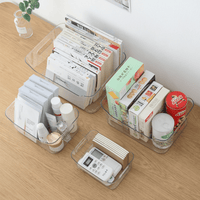 Clear plastic storage organizer tray holding books and small supplies on a table