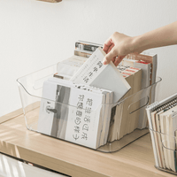 Clear plastic storage organizer bin with open front as hand places documents