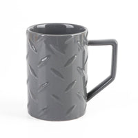 Gray ceramic mug with raised pattern and side handle