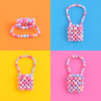 Mini acrylic beaded handbag with pink and blue bead pattern, arched top handle