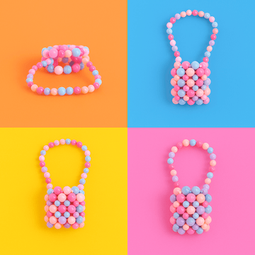 Mini acrylic beaded handbag with pink and blue bead pattern, arched top handle