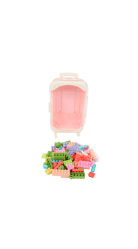Toy building block suitcase with pink case, lid open and blocks spilled