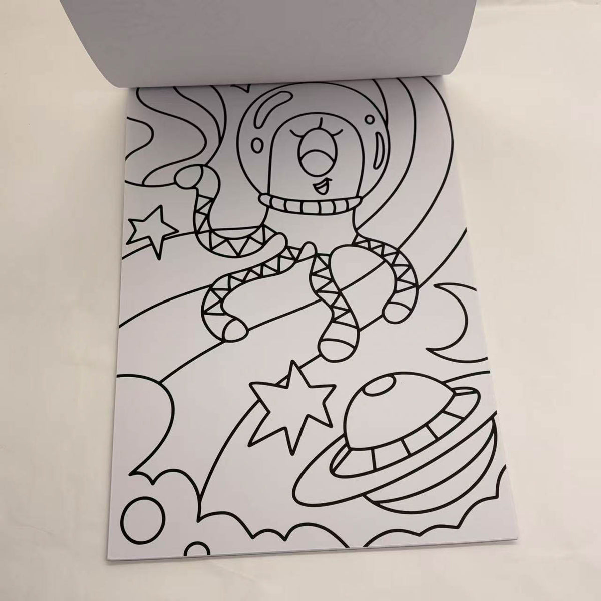 Open space coloring book page with astronaut and star outlines