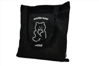 Black tote bag with bear logo on the front and top straps