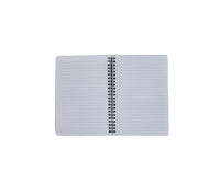 Open spiral notebook with blank ruled pages, black metal coil binding