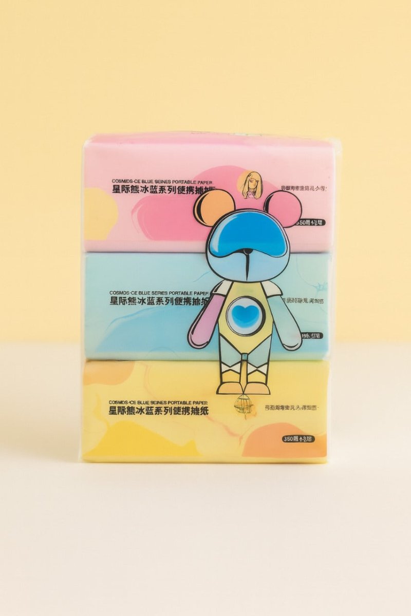 Portable tissues 3-pack with stacked pink, blue, and yellow boxes and cartoon graphic