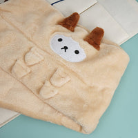 Llama baby blanket close-up: plush cream fabric with stitched face patch and brown ears