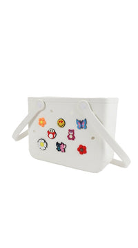 White silicone shower caddy with side handles and sticker charms on front panel