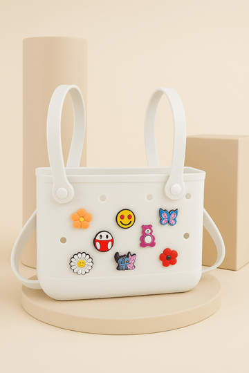White silicone shower caddy with two handles and sticker charms on front
