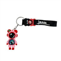 Astronaut cartoon keychain with red PVC figure, black strap, and metal key ring