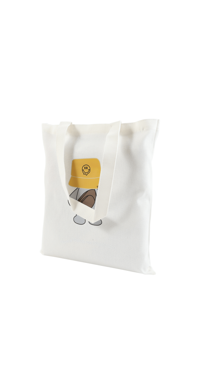 White canvas tote bag with bear wearing yellow bucket hat front graphic