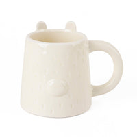 Cream ceramic mug with raised bear ears and side handle, smooth glossy finish