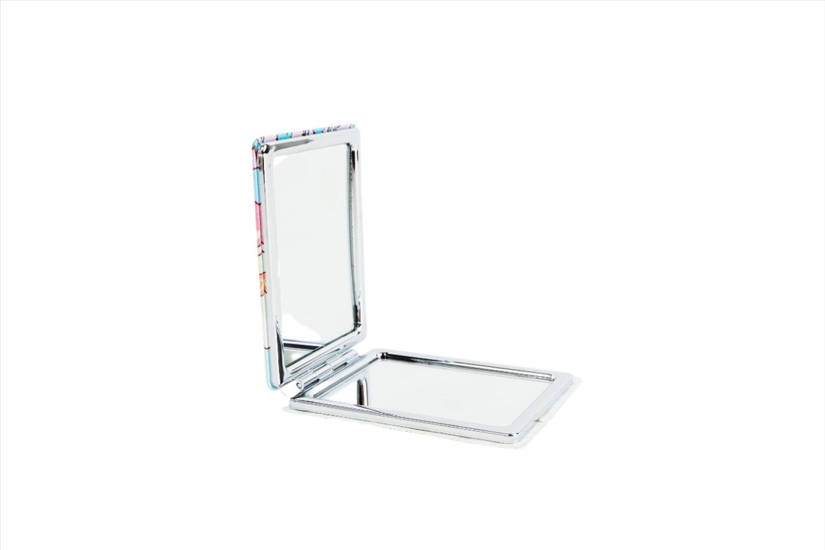 Compact mirror opened with reflective lid and base tray, showing metal hinge.