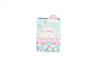 Compact mirror with a bear face and pastel landscape of clouds and flowers on cover.