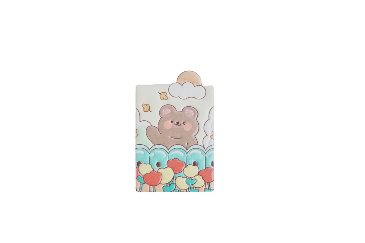 Compact mirror cover with bear face, pastel clouds, and colorful flowers and hearts.