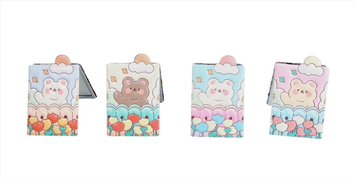 Compact mirrors with pastel bear, cloud, and balloon-themed covers in four colorways.