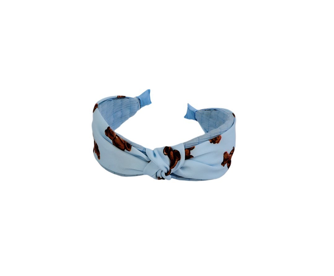 Knotted printed hairband in light blue with brown motif, knotted front