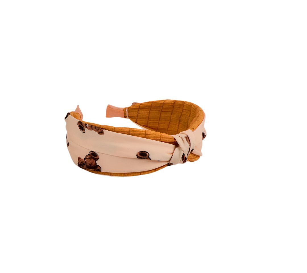 Knotted printed hairband with peach base, brown motif, orange inner lining