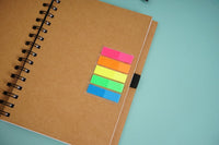Spiral notebook with stacked color sticky tabs on kraft brown cover