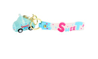 Colorful sweet-themed keychain with turquoise strap and pink S-shaped lettering