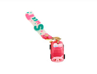 Pink keychain with gold ring and small toy car charm hanging from “Sweet” strap