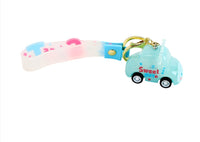 Light blue keychain with gold ring, clear strap, and light blue toy car charm