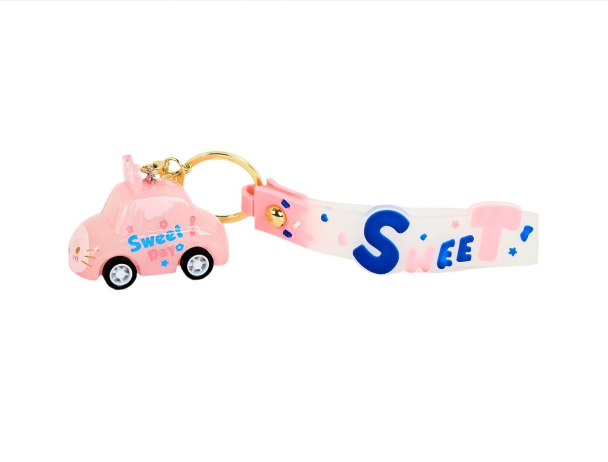 Pink keychain with gold ring, “Sweet” strap, and pink cat toy car charm
