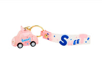 Pink keychain with gold ring, “Sweet” strap, and pink cat toy car charm