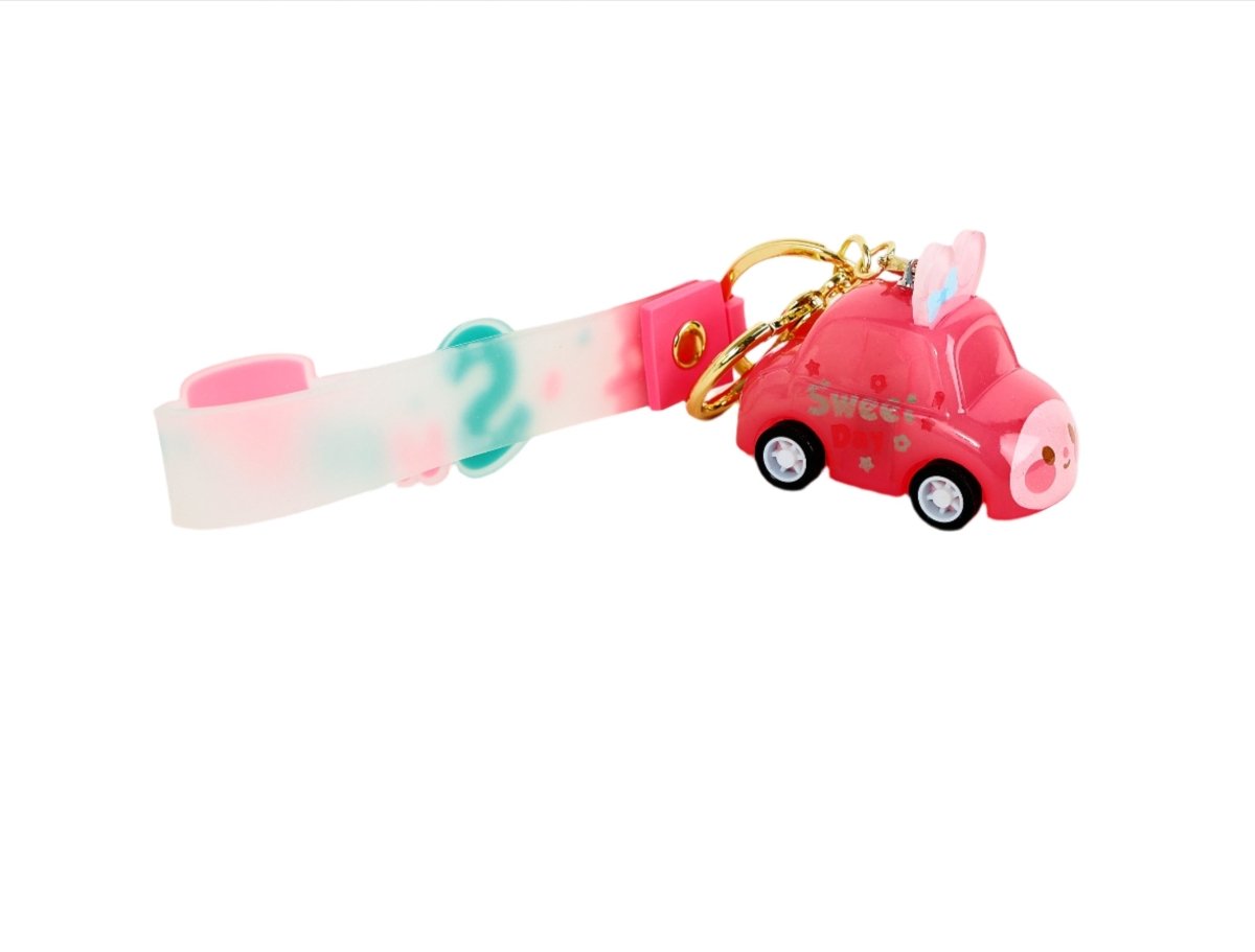 Pink keychain with gold ring, clear strap, and pink toy car charm