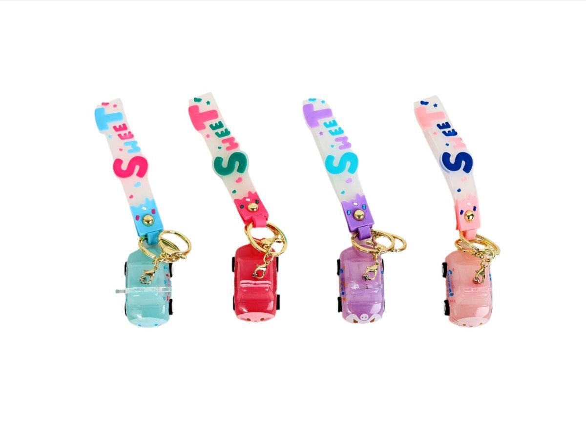 Set of four colorful keychains with lettered straps and mini cube charm cases