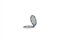 Compact mirror with open lid and round reflective insert, silver frame.