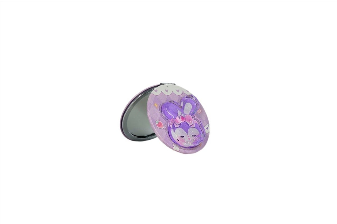 Compact mirror with purple bunny graphic on the lid, mirror open.