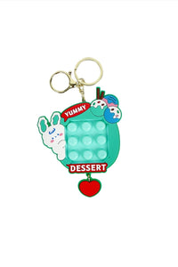 Bunny dessert silicone pop keychain, teal cube with YUMMIN and DESSERT labels, heart charm
