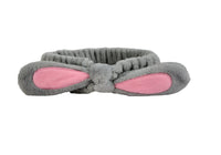 Gray plush rabbit-knot hair band with pink-lined ear pads